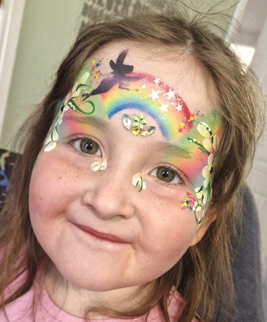 Girl with a fairy rainbow face paint in Telford
